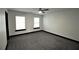 Spacious bedroom featuring neutral carpeting, ample natural light, and a modern ceiling fan at 657 S Grand Nw Ave, Atlanta, GA 30318