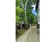 Long concrete driveway leading to the home with lush landscaping and mature trees at 657 S Grand Nw Ave, Atlanta, GA 30318