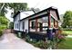 Charming two-story home with a black and white exterior, accented by a spacious, covered front porch and professional landscaping at 657 S Grand Nw Ave, Atlanta, GA 30318