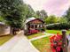 Charming two-story home featuring a cozy front porch and meticulously landscaped yard at 657 S Grand Nw Ave, Atlanta, GA 30318