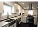 Well-lit kitchen with modern appliances, white cabinets, and seamless flow to a comfortable living space at 657 S Grand Nw Ave, Atlanta, GA 30318