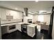 Modern kitchen with open island and living area in the background at 657 S Grand Nw Ave, Atlanta, GA 30318
