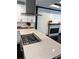 Kitchen island featuring gas range, quartz countertop and accent fireplace at 657 S Grand Nw Ave, Atlanta, GA 30318