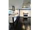 Modern kitchen with white cabinets, stainless steel appliances, and a view of the living room at 657 S Grand Nw Ave, Atlanta, GA 30318