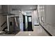 A modern kitchen with stainless steel appliances, countertops, and a view of the staircase at 657 S Grand Nw Ave, Atlanta, GA 30318