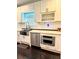 Close-up of kitchen featuring stainless steel appliances, white cabinets, and hardwood floors at 657 S Grand Nw Ave, Atlanta, GA 30318