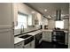Bright and modern kitchen with white cabinets, stainless steel appliances, and dark hardwood flooring at 657 S Grand Nw Ave, Atlanta, GA 30318