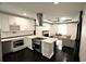A modern kitchen with stainless steel appliances, a kitchen island, and an open view to the Gathering room at 657 S Grand Nw Ave, Atlanta, GA 30318