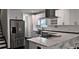 Contemporary kitchen boasting stainless steel appliances, white cabinetry, and a sleek island with seating at 657 S Grand Nw Ave, Atlanta, GA 30318