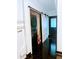 Convenient laundry room with stacked washer and dryer, storage, and hardwood floors at 657 S Grand Nw Ave, Atlanta, GA 30318