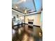 Open-concept living room with fireplace, dark hardwood floors, and a view of the kitchen at 657 S Grand Nw Ave, Atlanta, GA 30318