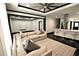 Open concept living room, view into a modern kitchen with bar seating and stainless steel appliances at 657 S Grand Nw Ave, Atlanta, GA 30318