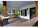Inviting front porch with wooden beams, black railings, and a view of the neighborhood at 657 S Grand Nw Ave, Atlanta, GA 30318