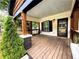 Cozy porch featuring stained wood columns, black trimmed windows and door, and a painted ceiling, inviting guests and residents alike at 657 S Grand Nw Ave, Atlanta, GA 30318