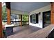 Inviting front porch with wooden floors, craftsman columns, and a painted ceiling, perfect for relaxing and enjoying the outdoors at 657 S Grand Nw Ave, Atlanta, GA 30318