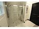 Modern walk-in shower with glass door, tile surround, and a multi-setting showerhead at 657 S Grand Nw Ave, Atlanta, GA 30318