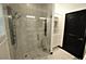 Shower boasts glass door, tile surround, and modern fixtures at 657 S Grand Nw Ave, Atlanta, GA 30318
