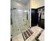 Modern bathroom shower featuring glass enclosure, marble tile walls, and dual shower heads at 657 S Grand Nw Ave, Atlanta, GA 30318