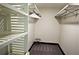 A walk-in closet with built-in shelving, gray carpet and a small stool at 657 S Grand Nw Ave, Atlanta, GA 30318