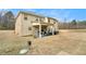 Spacious backyard features a covered patio area with ample seating and outdoor grill at 10 Tabor Trce, Oxford, GA 30054