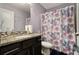 Charming bathroom featuring a granite vanity, floral shower curtain, and lilac accents at 10 Tabor Trce, Oxford, GA 30054