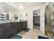 Bright bathroom featuring a double vanity, granite countertops, tile flooring, and access to the main bedroom at 10 Tabor Trce, Oxford, GA 30054