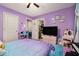 Bright bedroom with purple walls, plush carpets, playful accents, and cheerful decor at 10 Tabor Trce, Oxford, GA 30054