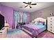Vibrant bedroom with bright purple walls, plush carpets, and comfortable furnishings at 10 Tabor Trce, Oxford, GA 30054