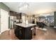 Open kitchen with granite counters, stainless appliances, an island and wood floors at 10 Tabor Trce, Oxford, GA 30054