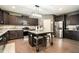 Well-equipped kitchen featuring dark wood cabinetry, stainless steel appliances and an island with seating at 10 Tabor Trce, Oxford, GA 30054