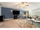 A living room with a modern bar, plush rug, and comfortable seating highlighted by a large-screen television at 10 Tabor Trce, Oxford, GA 30054