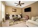 Cozy living room featuring plush carpeting, ceiling fan, and a comfortable sofa at 10 Tabor Trce, Oxford, GA 30054