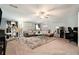 Spacious living room with plush carpet, modern furnishings, and a stylish bar area at 10 Tabor Trce, Oxford, GA 30054