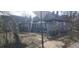 Exterior view of a two-story home with a front yard, landscaping, and a chain link fence at 540 Langhorn Sw St, Atlanta, GA 30310