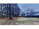 Spacious backyard with mature trees and a wooden fence providing privacy, ideal for outdoor activities at 805 Kilkenny Cir, Lithonia, GA 30058