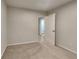 View of an empty bedroom with plush carpeting and neutral paint, showcasing a peaceful and inviting atmosphere at 805 Kilkenny Cir, Lithonia, GA 30058