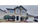 Charming two-story home features a well-manicured lawn and a classic stucco exterior at 805 Kilkenny Cir, Lithonia, GA 30058