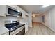 Modern kitchen with stainless steel appliances, ample counter space, and wood-look floors at 805 Kilkenny Cir, Lithonia, GA 30058