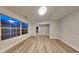 Bright living room featuring wood-look floors, large window, and a fresh, neutral palette at 805 Kilkenny Cir, Lithonia, GA 30058