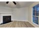 Bright living room featuring a fireplace, large window, and wood-look floors at 805 Kilkenny Cir, Lithonia, GA 30058