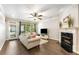 Cozy living room with a fireplace, hardwood floors, and ample natural light creating a warm atmosphere at 1693 Carr Nw Cir, Atlanta, GA 30318