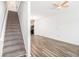 Inviting living room featuring carpeted stairs, wood-look floors, and modern lighting at 1732 Pryor Sw Rd # 403, Atlanta, GA 30315