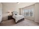 Comfortable bedroom with a large window, soft carpet, and a stylish headboard at 2499 Village Park Bend, Duluth, GA 30096