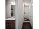 Hallway with connecting bath and stair access, featuring neutral walls and fixtures at 2499 Village Park Bend, Duluth, GA 30096