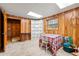 Basement space with wood paneled walls, featuring a small table, a bookcase, and an open doorway at 2671 Lee Ann Dr, Marietta, GA 30066
