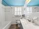 Bright bathroom with a blue ceiling, a tiled bathtub, and a vanity with a modern sink at 2671 Lee Ann Dr, Marietta, GA 30066