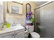Compact bathroom with a glass-enclosed shower, tiled walls, and efficient storage at 2671 Lee Ann Dr, Marietta, GA 30066