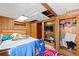 Bedroom featuring wood paneled walls, built-in shelving, a bed, and a doorway to another room at 2671 Lee Ann Dr, Marietta, GA 30066