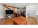 Open living room with hardwood floors, exposed beams, and a view of the staircase at 2671 Lee Ann Dr, Marietta, GA 30066