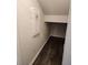 Unfinished basement storage area with dark floors and a utility panel on the wall at 3765 Davis Cir, Duluth, GA 30096